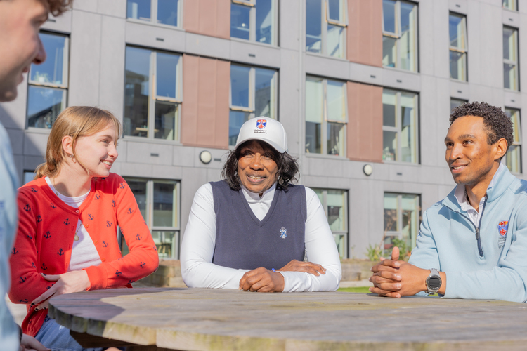 Renee Powell talking with students outside Powell Hall